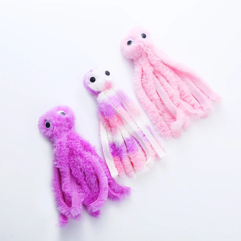 Trois pieuvres en peluche posées à plat